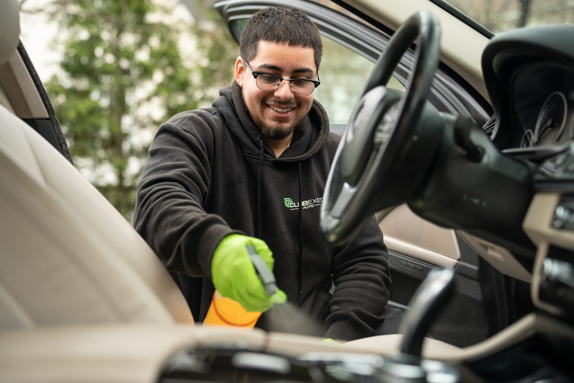 ClubExec Auto technician detailing a vehicle interior.