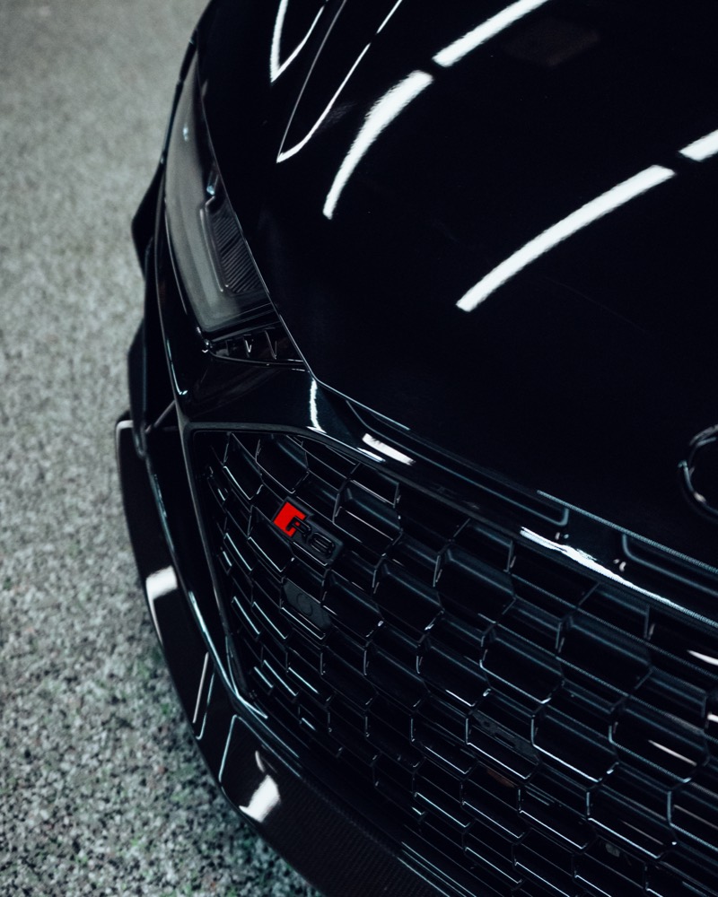 Close-up of glossy ceramic coated vehicle front.