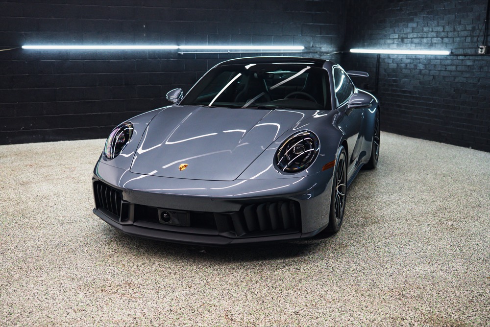 Front view of a protected Porsche showing deep gloss in the ClubExec studio.